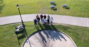 Lab participants waving for aerial drone photograph